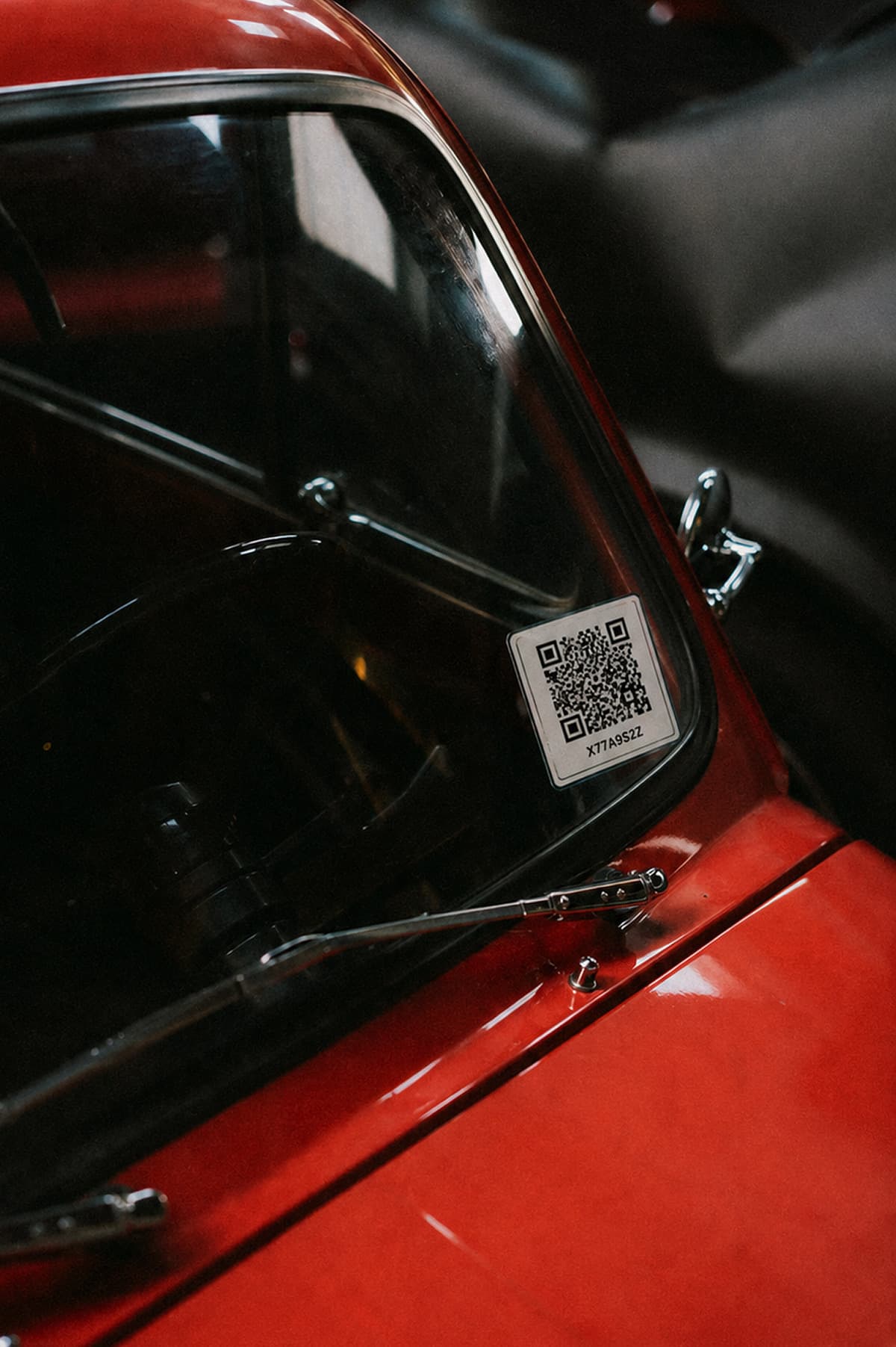 QR display sticker connecting a vehicle to its public page, voting, and results